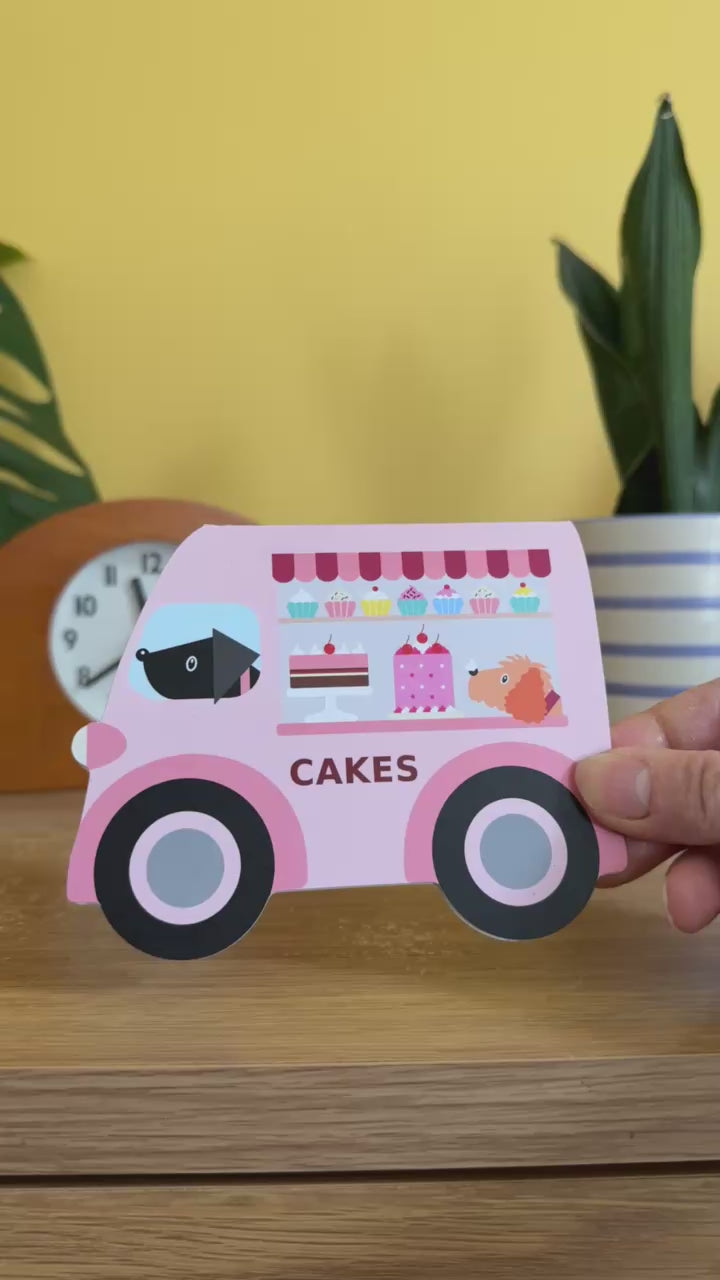 card cut into the shape of a vintage pink van selling cakes